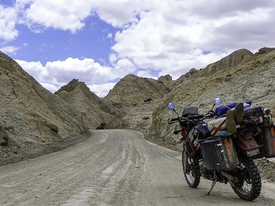 A lone stretch of Ruta 40 cutting through golden coiron grassland toward the Andes